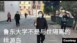 中國山東省魯東大學研究生孫健在校園內舉牌要求將校園解封。 （照片來自維權網）