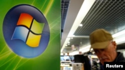 FILE - A man walks by the logo of Microsoft in a shop of Brussels, Sept. 17, 2007. 