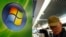 FILE - A man walks by the logo of Microsoft in a shop of Brussels, Sept. 17, 2007. 