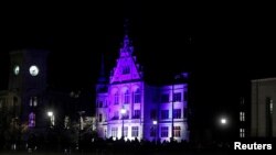 FILE - The Stadthaus building is illuminated in the colors of the Ukrainian flag, following Russia's invasion of Ukraine, in Zurich, Switzerland Feb. 28, 2022.