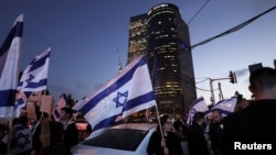 Israelis protest a wave of deadly attacks at a main junction in Tel Aviv, Israel, March 30, 2022. 