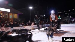 FILE - Veteran musher Brent Sass of Eureka, Alaska, crosses the finish line of the 50th running of the Iditarod, claiming his first Iditarod Trail Sled Dog Race championship in Nome, Alaska, March 15, 2022.