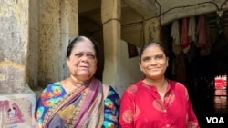 Ranjana Gurav (on right) with her mother says there is a strong sense of community in the tenements. (Anjana Pasricha/VOA)