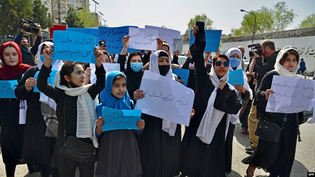 Afghan women and girls take part in a protest in front of the Ministry of Education in Kabul, Afghanistan, March 26, 2022, demanding that secondary schools be reopened for girls. 