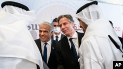After meeting for the Negev Summit, Israel's Foreign Minister Yair Lapid, and U.S. Secretary of State Antony Blinken, shake hands with Bahrain's Foreign Minister Abdullatif bin Rashid al-Zayani. (File)
