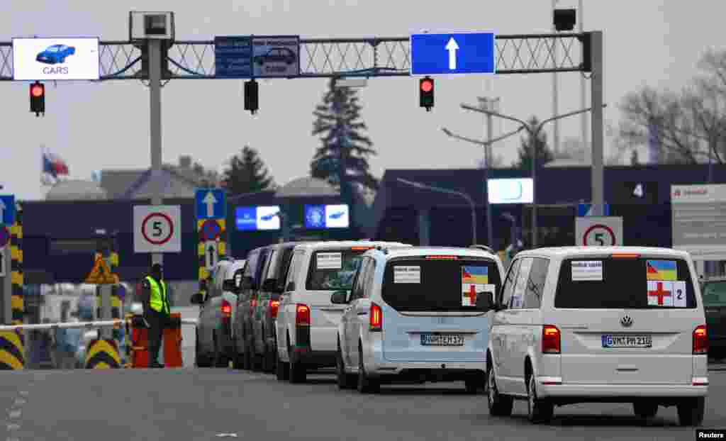 A humanitarian medical convoy with cars from Germany drives through a border crossing from Poland to Ukraine, where people fleeing the Russian invasion of Ukraine at the border checkpoint in Medyka, Poland, March 7, 2022.