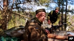 Ukrainian servicemen guard their position near Brovary, north of Kyiv, March 17, 2022.