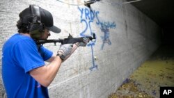 KelTec employee Bobby Cormier tests a 9mm SUB2000 rifle, similar to ones being shipped to Ukraine, at the company's manufacturing facility, March 17, 2022, in Cocoa, Fla.
