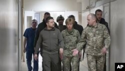 Ukrainian President Volodymyr Zelenskyy visits a hospital in Kyiv, Ukraine, March 13, 2022. (Ukrainian Presidential Press Office via AP)