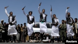 FILE - Houthi supporters perform the traditional Baraa dance during a ceremony held to collect supplies for Houthi fighters, in Sanaa, Yemen, September 22, 2019.