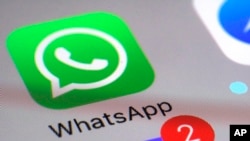 FILE: FILE - This Friday, March 10, 2017 photo shows the WhatsApp communications app on a smartphone, in New York.