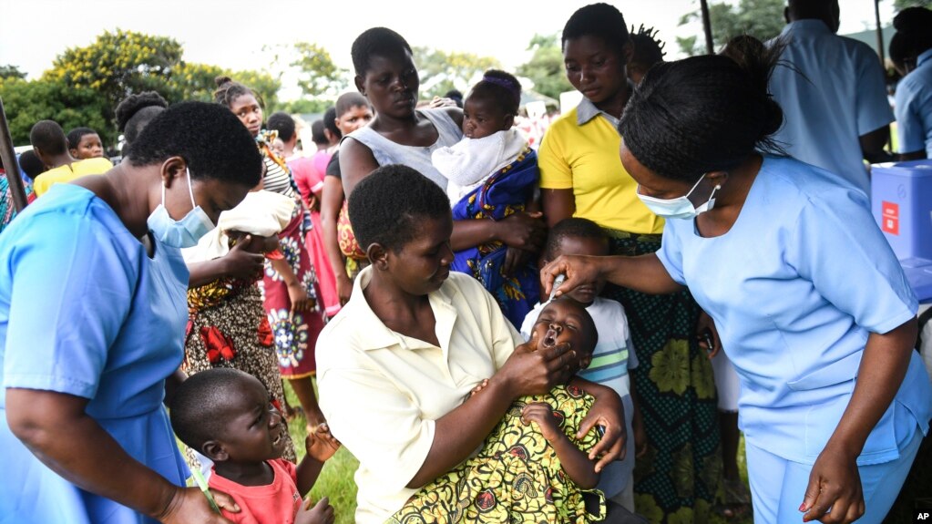 A child receives a polio vaccin, during the Malawi Polio Vaccination Campaign Launch in Lilongwe Malawi, Sunday March 20, 2022. ((AP Photo/Thoko Chikondi))