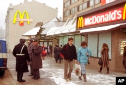 FILE - People walk past Moscow's first McDonalds a day before its opening, in Moscow's Pushkin Square, Jan. 30, 1990.