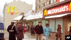 FILE - People walk past Moscow's first McDonalds a day before its opening, in Moscow's Pushkin Square, Jan. 30, 1990. 