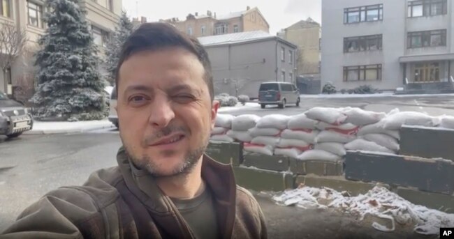 In this March 8, 2022, image from video provided by the Ukrainian Presidential Press Office and posted on Instagram, Ukrainian President Volodymyr Zelenskyy winks as he speaks in Kyiv, Ukraine. (Ukrainian Presidential Press Office via AP)