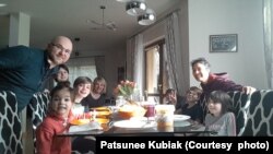 Patsunee Kubiak (second from right), a Thai housewife and her Polish husband Patryk Kubiak (left) host a Ukrainian family in the Kubiaks' house in Kolonia Warszawska, Poland