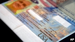 FILE - A partially redacted U.S. passport with an "X" gender designation rests on a table in Fort Collins, Colorado, Oct. 27, 2021.