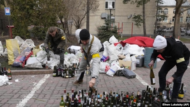 FILE - Civil defense members prepare Molotov cocktails in Kyiv, Ukraine, Feb. 27, 2022. (AP Photo/Efrem Lukatsky, File)