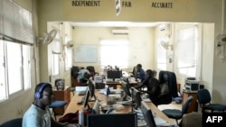 South Sudan's 'Eye Radio' journalists, sit working at their desks in Juba, in the South Sudan capital on March 2, 2019.