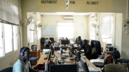 South Sudan's 'Eye Radio' journalists, sit working at their desks in Juba, in the South Sudan capital on March 2, 2019.