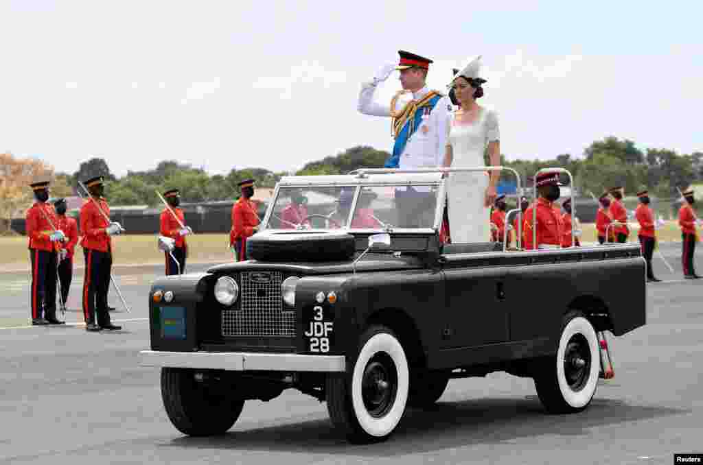 Britain&#39;s Prince William and Catherine, Duchess of Cambridge, ride in an old Land Rover used by Britain&#39;s Queen Elizabeth during her visit to Jamaica, as they leave the Commissioning Parade for service members completing the Caribbean Military Academy&#39;s Officer Training Program, in Kingston, Jamaica.
