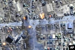 FILE - This satellite image provided by Maxar Technologies shows burning buildings in a residential area in northeast Chernihiv, Ukraine, on March 16, 2022.