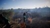 Felix Fitiavantsoa, 20, and his brother start a fire in a wooded area in order to start cultivating it, in the Tsihombe commune, Androy region, Madagascar, February 13, 2022. (REUTERS/Alkis Konstantinidis )