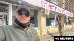 Emad Ballack, an Iraqi-American Kurd and businessman, who owns a restaurant in Kyiv, takes a selfie near the TV tower that was hit in the attacks during Russia's invasion, in Kyiv, Ukraine March 12, 2022. (Courtesy Emad Ballack via Reuters)