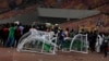 Angry football fans break the players' bench as violence broke out at the World Cup 2022 qualifying football match between Nigeria and Ghana at the Moshood Abiola National Stadium in Abuja, March 29, 2022.