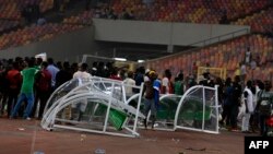 Angry football fans break the players' bench as violence broke out at the World Cup 2022 qualifying football match between Nigeria and Ghana at the Moshood Abiola National Stadium in Abuja, March 29, 2022.