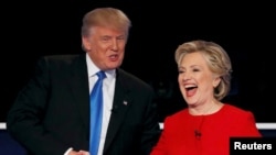 FILE - Republican U.S. presidential nominee Donald Trump shakes hands with Democratic U.S. presidential nominee Hillary Clinton at the conclusion of their first presidential debate at Hofstra University in Hempstead, New York, Sept. 26, 2016.