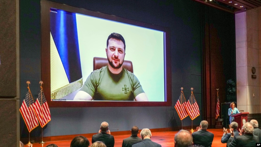 Members of Congress give Ukraine President Volodymyr Zelensky a standing ovation before he speaks in a virtual address to Congress in the U.S. Capitol Visitors Center Congressional Auditorium in Washington, on Wednesday, March 16, 2022.