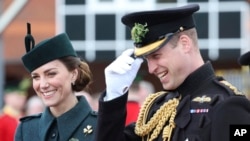 FILE- Britain's Prince William and Kate, Duchess of Cambridge attend the 1st Battalion Irish Guards' St. Patrick's Day Parade at Mons Barracks, March 17, 2022 in Aldershot, England. Prince William and his wife Catherine are embarking on a tour to Central America and the Caribbean, even as some countries in the region mull cutting ties to the British monarchy. The couple will visit Belize, Jamaica and the Bahamas on the week-long journey that starts Saturday, March 19, 2022. (Chris Jackson/Pool via AP, file)