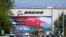 FILE - Traffic drives in view of a massive Boeing Co. production plant, where images of jets decorate the hangar doors, April 23, 2021, in Everett, Wash.