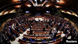 Ukrainian Prime Minister Denys Shmyhal receives standing ovation from Members of the Parliamentary Assembly of the Council of Europe after his address via videolink, in an extraordinary session to discuss Russia's invasion of Ukraine, in Strasbourg, France, March 14, 2022.