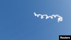 A trail of smoke is seen after Blue Origin's rocket New Shepard blasted off, on billionaire Jeff Bezos's company's fourth suborbital tourism flight with a six-person crew, near Van Horn, Texas, U.S., March 31, 2022.