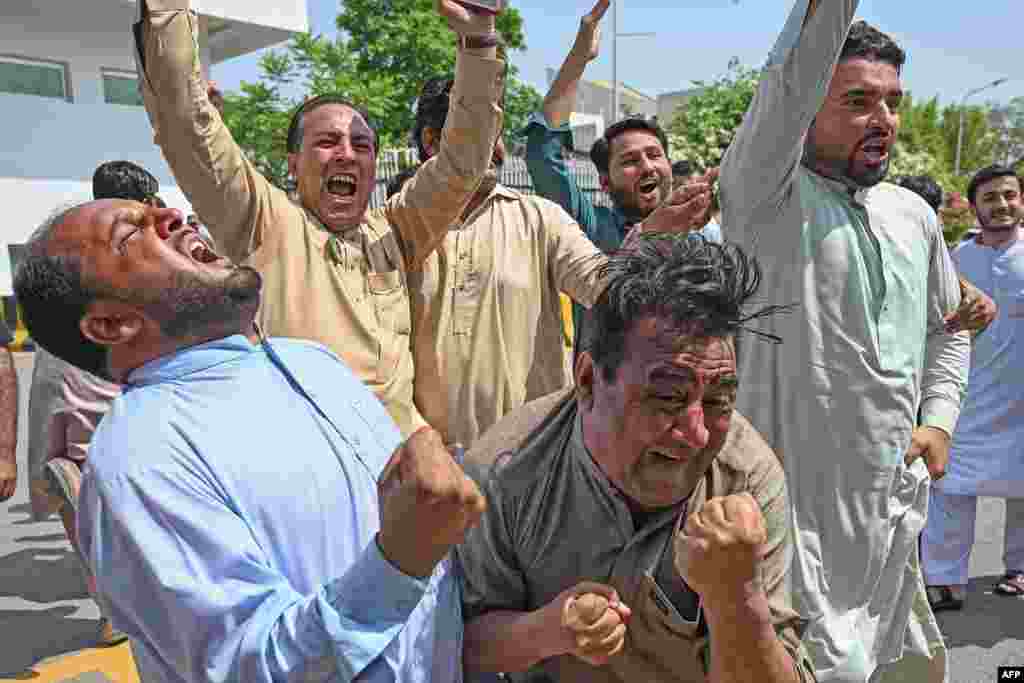 Supporters of Pakistan Tehreek-e-Insaf (PTI) party of Prime Minister Imran Khan shout slogans outside the Parliament House building in Islamabad, Pakistan.