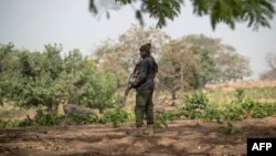 FILE - A policeman stands guard in Kaduna State, Nigeria, Feb. 22, 2019.