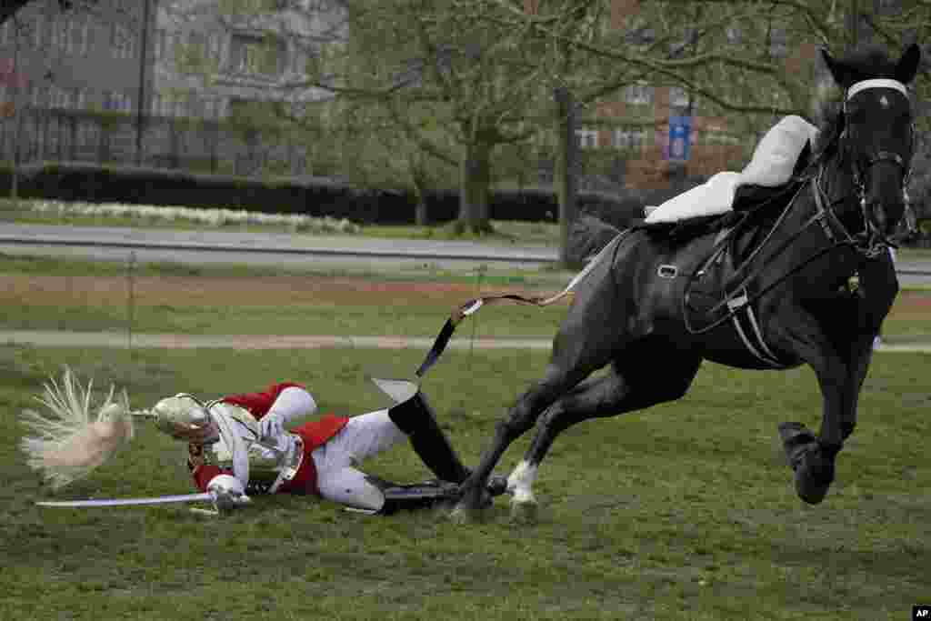 A soldier of the Household Cavalry Mounted Regiment falls off a horse during preparations for this year&#39;s Platinum Jubilee celebrations at Hyde Park in London.