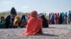 FILE - A girl sits as she waits in line with dozens of other internally displaced people to be registered by local authorities at a compound in Semera, Afar region, Ethiopia, Feb. 14, 2022. 
