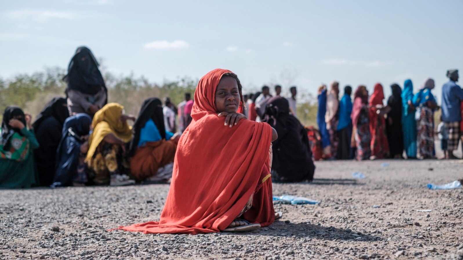 FILE - A girl sits as she waits in line with dozens of other internally displaced people to be registered by local authorities at a compound in Semera, Afar region, Ethiopia, Feb. 14, 2022. 