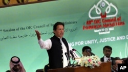 Pakistan's Prime Minister Imran Khan speaks at the start of a two-day gathering of the 57-member Organization of Islamic Cooperation, at the Parliament House in Islamabad, March 22, 2022.