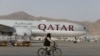 FILE - A Taliban soldier patrols on a bike in front of a Qatar Airways flight at the international airport in Kabul, Afghanistan, September 10, 2021. 