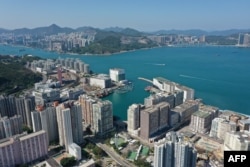 FILE - This aerial photo shows a view of residential and commercial tower blocks on the eastern side of Hong Kong island, Apr. 3, 2022.