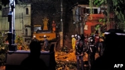 Rescue workers are seen at the site of a landslide in which a mother and six of her children were killed, in Paraty, Rio de Janeiro state, April 2, 2022.