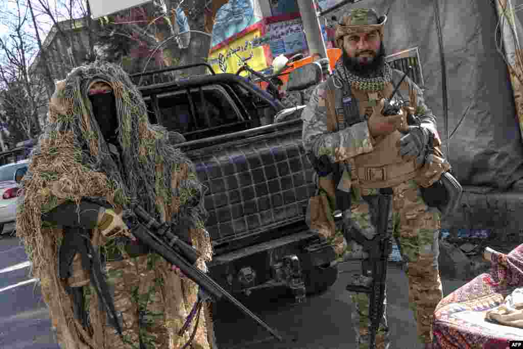 Taliban security workers stand guard along a road in Kabul, Afghanistan. Hundreds of young women were prevented from entering Afghan university campuses, a day after the nation&#39;s Taliban rulers banned them from higher education.