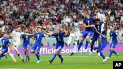 England's Harry Kane, center right, tries to head the ball during the World Cup group B soccer match between England and the United States at Al Bayt Stadium in Al Khor, Qatar, Nov. 25, 2022.