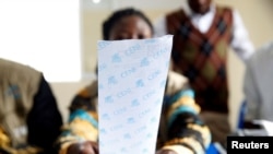 An official of Congo's Independent National Electoral Commission (CENI) reads out the presidential elections results of one polling station at a tallying centre in Kinshasa, Democratic Republic of Congo, January 4, 2019. 
