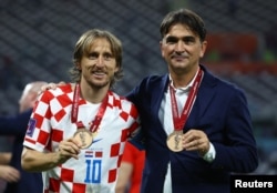 Croatia's coach Zlatko Dalic and captain Luca Modric pose with their bronze medals after winning third place at the 2022 FIFA World Cup