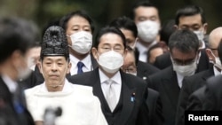 Japan's Prime Minister Fumio Kishida and his cabinet ministers are led by a shinto priests during a customary New Year's visit at Ise shrine in Ise, central Japan, in this photo taken by Kyodo Jan. 4, 2023.